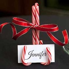 a candy cane with a name tag tied to it