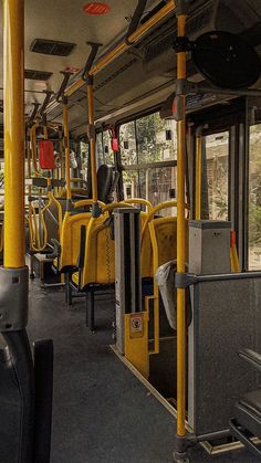 the interior of a public transit bus with lots of yellow and black seats on it