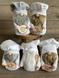 four stuffed gnomes wearing chef's hats and aprons with price tags on them