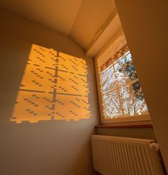 the light is shining on the wall in the room next to the radiator