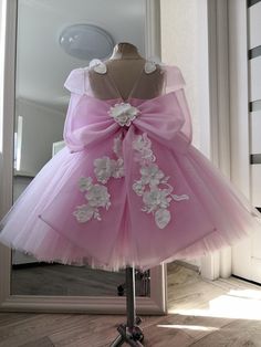 An incredibly beautiful pink and white dress with glitter and 3D flowers is sure to please your baby. The dress is made of pink and white tulle with glitter. The bodice of the dress is decorated with 3d white flowers and embroidery with beads and sequins. A dress above the knee with a full tutu skirt. The back of the dress is decorated with a neckline and a large bow with flowers. All our dresses are distinguished by high quality tailoring and fabrics. Tailoring takes 10-14 days from the date of order. If you have any questions, please do not hesitate to ask them to me, and I will do my best to make you satisfied with your purchase in my store. Princess Style Dresses With Floral Applique For Pageants, Party Princess Dress With Pink Bow, Pink Princess Ball Gown Pageant Dress, Pink Tulle Gown For Dress-up, Pink Ball Gown For Dress-up, Pink Tulle Dress With Bow, Pink Tulle Gown For Dress-up Occasions, Wedding Dresses With 3d Flowers And Tulle, Wedding Dress With 3d Flowers In Tulle