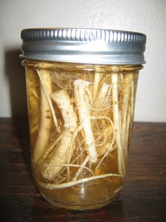 a jar filled with sliced up bananas on top of a wooden table