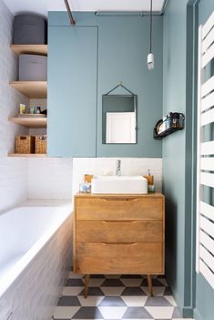 a bathroom with a sink, mirror and bathtub