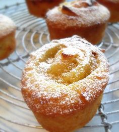 several powdered sugar muffins cooling on a wire rack