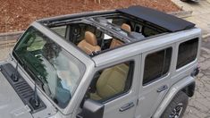 a grey jeep parked on the side of a road