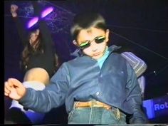 a young man wearing sunglasses holding a white frisbee