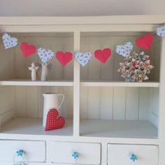 the shelves are decorated with paper hearts