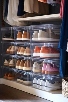 an organized closet with clear plastic bins filled with shoes and clothing hanging on the wall