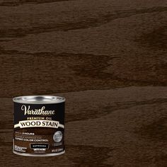 a can of wood stain sitting on top of a wooden floor