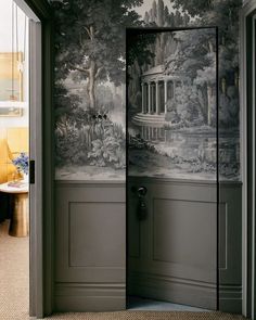 an open door leading to a room with a wallpapered mural on the walls