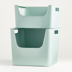 two plastic storage containers stacked on top of each other, one is green and the other is white