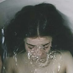 a woman with her face covered in water