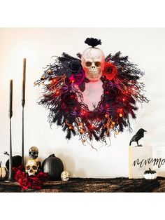 a halloween wreath is hanging on the wall next to candles and other decorations with skulls