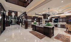 a large kitchen with marble floors and wooden cabinets