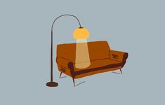 a couch with a lamp on top of it and a floor lamp in front of it