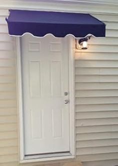 a white door with a purple awning over it