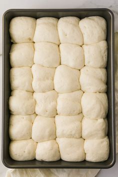 a pan filled with dough on top of a wooden table