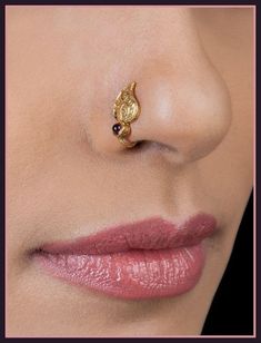 a woman's nose with a gold nose ring