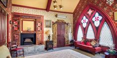 a bedroom with a large bed and stained glass windows in the wall, along with other furniture