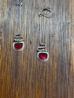 Lovely faceted garnet and sterling silver drop earrings.  Unique, simple, sleek and elegant.  2.5 inches long with motion when you move or walk.  Definately an attention grabber.  I love these earring.  I enjoy wearing them.  Light, fun, and look great with anything. (Even jeans) Look for matching bracelet and necklace in my shop listing. https://ellequentjewelry.etsy.com/listing/1817382836 Earrings Stones, Attention Grabber, Cool Earrings, Metalsmithing Jewelry, January 2025, Jeans Look, Bracelet And Necklace, Sterling Silver Drop Earrings, Garnet Earrings