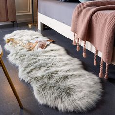 a white sheepskin rug sitting on top of a bed