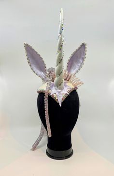 Handmade one-of-a-kind headpiece inspired by the 1982 anime film, The Last Unicorn. Hand-painted lavender leather star and ears, horn with iridescent sparkle and Swarovski crystals, beaded trim and rhinestone chain trim, white brocade fabric. The abundant spiral "hair" is hand-made silicone art from the Carol Motty studio. Carol Motty was a notable silicone artist popular in the 80's and 90's. It's a special addition! This is a very comfortable and fun piece to wear. It's secured to the head with an adjustable elastic strap. Unicorn Masquerade Mask, Unicorn Hair Accessories, Adult Unicorn Costume Diy, Adult Unicorn Costume, Unicorn Headdress, White Brocade Fabric, Halloween Headpiece, Unicorn Headpiece, Silicone Art