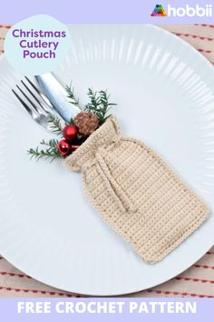 a white plate topped with a crochet christmas cookie and a bag on top of it