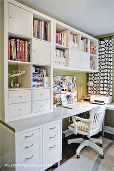 a white desk sitting under a window next to a bookshelf filled with books