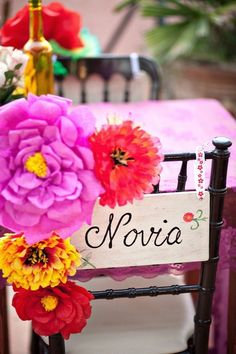 a chair with flowers on it and a sign that says noria