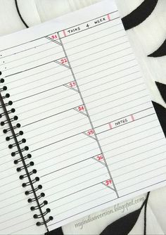 a spiral notebook with lines drawn on it and the numbers in red are lined up next to each other