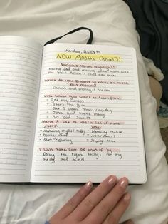 an open notebook with writing on it in someone's hand