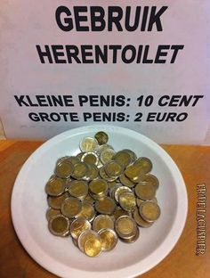 a white plate topped with lots of gold coins next to a sign that says gebruk herentollett