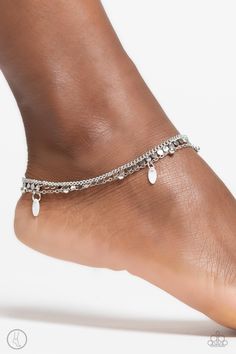 A dainty silver chain with a dainty silver disc fringe, combines with another dainty silver chain, this one infused with silver studs and oval white shells for a twinkling, beachy statement. Features an adjustable clasp closure. Sold as one individual anklet. Silver Chain Anklet, Coil Bracelet, Surf City, Toggle Bracelet, Chain Anklet, Stretchy Bracelets, Paparazzi Accessories, Paparazzi Jewelry, Cord Bracelets