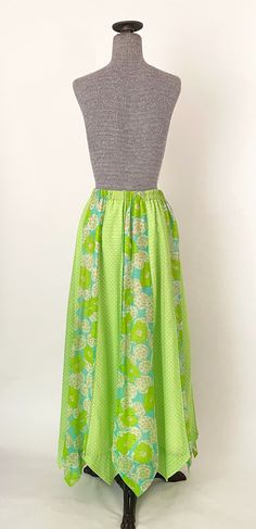 "60s lime green mod print maxi skirt with zig zag hem. Fully lined with sheer shell, alternating polka dot and floral panels and a stretchy elastic waistband. Condition: some spotting inside the lining around the waistband area with a couple small spots on the shell and minor seam-wear on the waistband -- please see photos. Overall great vintage condition. All measurements are taken with the garment laying flat and doubled for the bust, waist, and hips. Waist: 27\" - 30\" elastic waist Hips: 50\ Green A-line Maxi Skirt For Spring, Green Lined Maxi Skirt For Spring, Retro Green A-line Skirt, Green Relaxed Maxi Skirt For Spring, Green Relaxed Fit Maxi Skirt For Spring, Fitted Green Cotton Maxi Skirt, Green Fitted A-line Maxi Skirt, Green Full Maxi Skirt For Summer, Green Lined Maxi Skirt