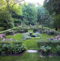 the garden is full of flowers and trees