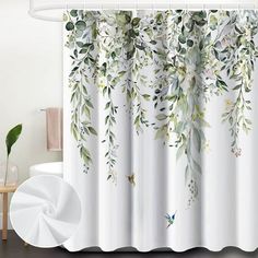 the shower curtain is decorated with watercolor leaves and flowers on it's side