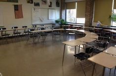 an empty classroom with desks and chairs