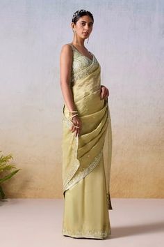 Sage green saree featuring sequin-bead embroidered floral vine motif border and floral buttis. Paired with sequin embellished padded blouse. - Aza Fashions Sleeveless Silk Saree For Wedding, Elegant Sleeveless Pre-draped Saree With Resham Embroidery, Elegant Sleeveless Chanderi Blouse Piece, Elegant Sleeveless Blouse With Resham Embroidery, Sage Green Saree, Silk Saree For Wedding, Padded Blouse, Border Saree, Green Saree