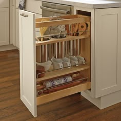 an open cabinet in a kitchen filled with utensils