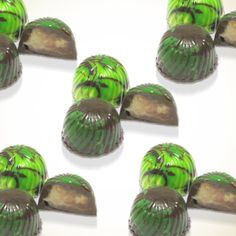 there are many chocolates with green frosting on them