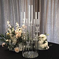 a table with flowers and candles on it