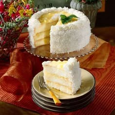 two pieces of cake sitting on top of plates next to each other with flowers in the background