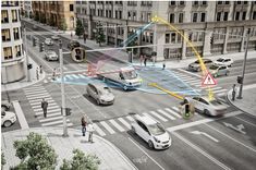 an aerial view of a city intersection with cars and people crossing the street in front of tall buildings