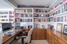 a home office with bookshelves full of books