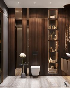 a modern bathroom with wood paneling and white flowers in vases on the counter