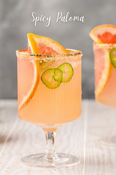 two glasses filled with orange and cucumber drink