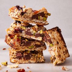 a stack of crackers stacked on top of each other with nuts and dried fruit