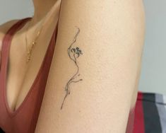 a woman with a small tattoo on her arm