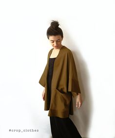 Handmade khaki green boho kimono robe with pockets. Our kimono robe comes in a wide and loose style, one-size-fits all. This is one of our favourite kimono jackets as it is made with a slightly heavier khaki green cotton viscose fabric, giving it a more oversized shirt/ cardigan feel when worn. This is a beautiful simple fabric which creates strong shadows in movement due to its very slight sheen that we are happy shows in the photographs too. Finished with wide arm quarter length sleeves and a Fall Kimono With Relaxed Fit And Kimono Sleeves, Fall Kimono With Pockets And Relaxed Fit, Fall Kimono With Pockets In Relaxed Fit, One Size Kimono For Fall Loungewear, One Size Fall Kimono For Loungewear, Fall Season Relaxed Fit Kimono With Pockets, Fall Season Relaxed Fit Wrap Kimono, Oversized Kimono With Kimono Sleeves For Winter, Oversized Winter Kimono With Kimono Sleeves