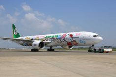 an airplane with hello kitty painted on it's side sitting on the tarmac